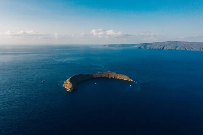 Aerial view of the crescent-shaped Molokini crater in deep blue water